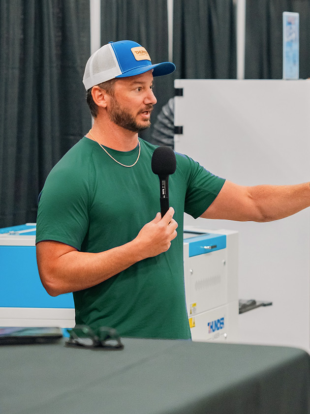 Clay Luttrell speaking into a microphone at a business event